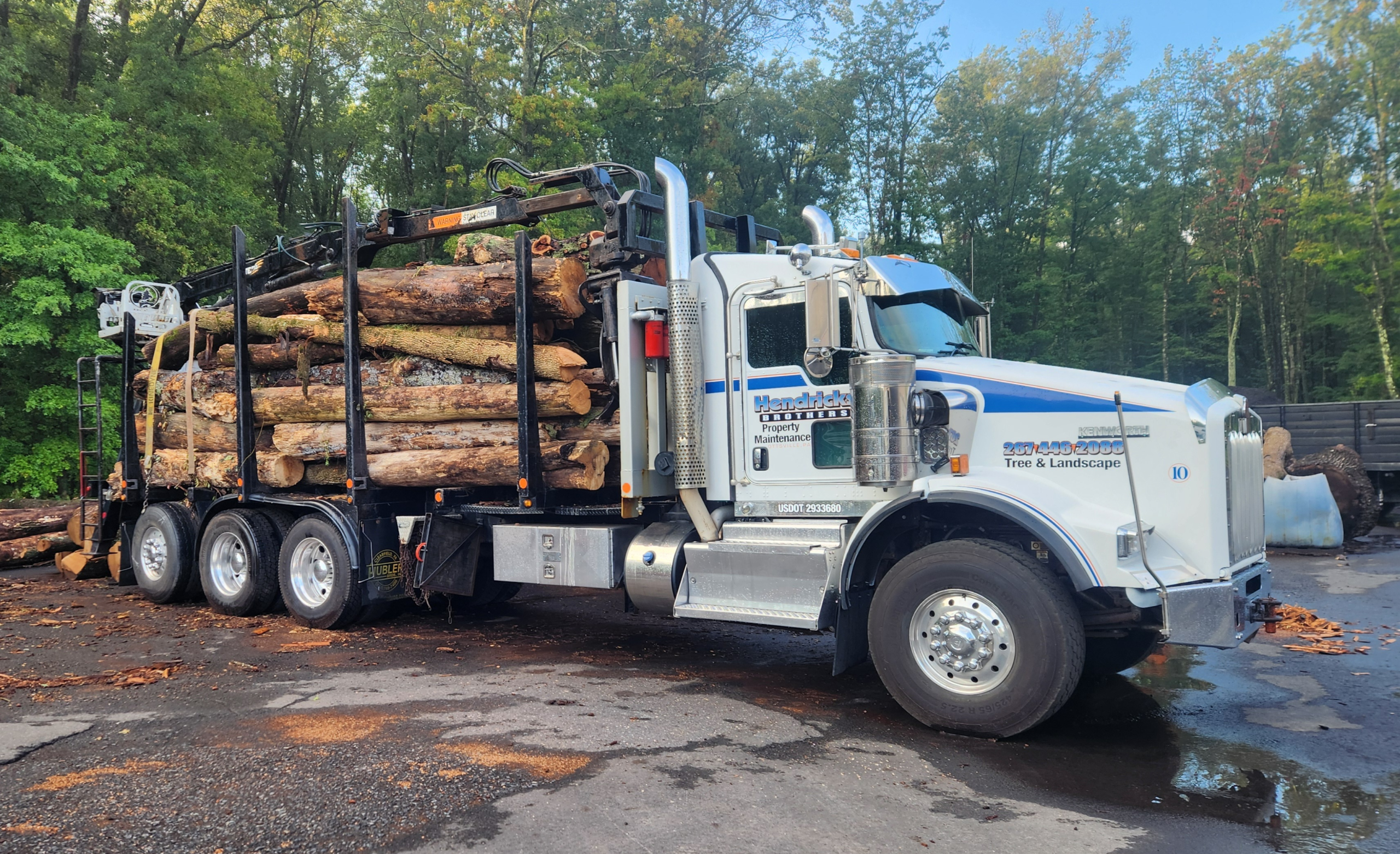 Bucket truck loaded with lumber after tree work